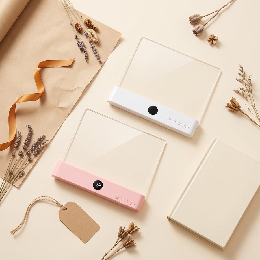 Two reading lights, white and pink, in a gift flat-lay with kraft paper and ribbon